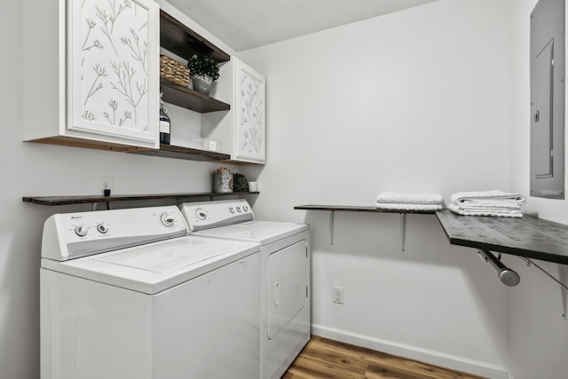 7565 N County Line Rd, Fairview, TN 37062 - washroom featuring wood finished floors, baseboards, washer and clothes dryer, electric panel, and cabinet space