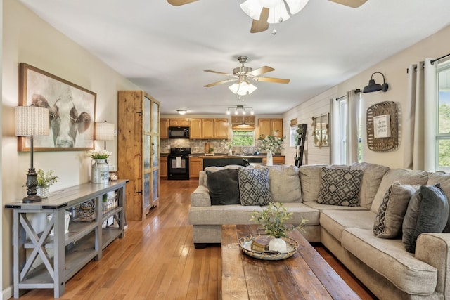 7565 N County Line Rd, Fairview, TN 37062 - living area featuring a healthy amount of sunlight, ceiling fan, and light wood-style flooring