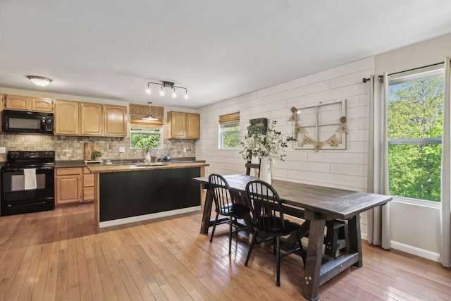7565 N County Line Rd, Fairview, TN 37062 - kitchen with light brown cabinetry, tasteful backsplash, a center island, black appliances, and light wood-style floors
