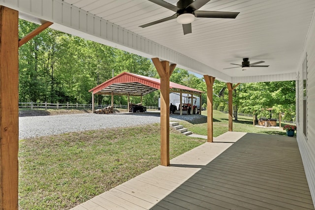 7565 N County Line Rd, Fairview, TN 37062 - wooden terrace with a ceiling fan, fence, a yard, and a carport