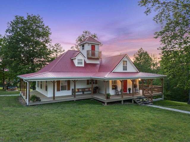 7565 N County Line Rd, Fairview, TN 37062 - back of house at dusk with a porch, a lawn, a balcony, and metal roof