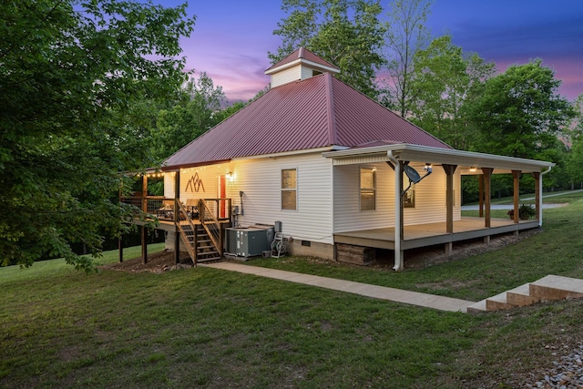 7565 N County Line Rd, Fairview, TN 37062 - back of property with a deck, central AC unit, crawl space, metal roof, and a lawn