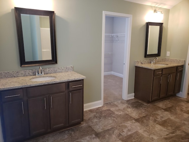 2260 Viking Ct, Murfreesboro, TN 37127 - bathroom featuring two vanities, baseboards, a sink, and a spacious closet
