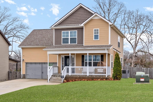 view of front of property with a front lawn, driveway, fence, a porch, and a garage
