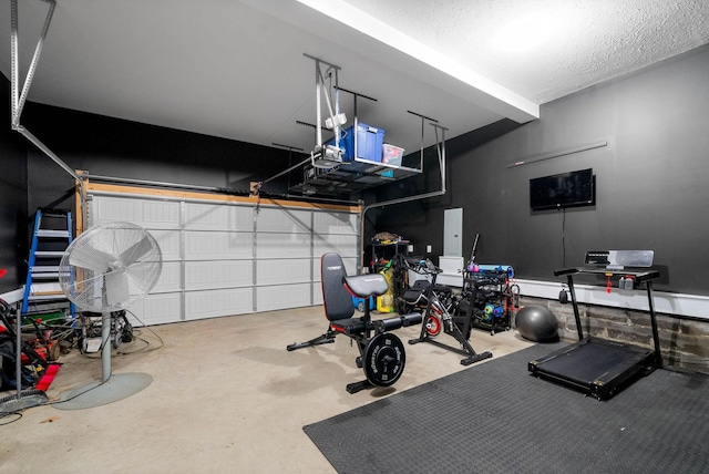 workout room featuring a garage and a textured ceiling