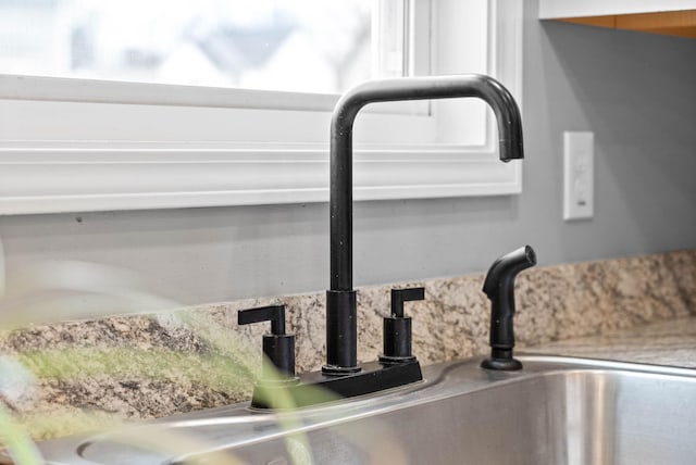 details featuring tasteful backsplash and light stone countertops