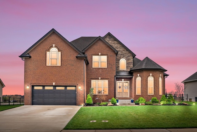 1885 Shield Dr, Clarksville, TN 37043 - french country home featuring concrete driveway, a front lawn, fence, a garage, and brick siding