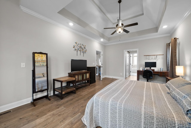 1885 Shield Dr, Clarksville, TN 37043 - bedroom featuring a tray ceiling, wood finished floors, visible vents, crown molding, and baseboards