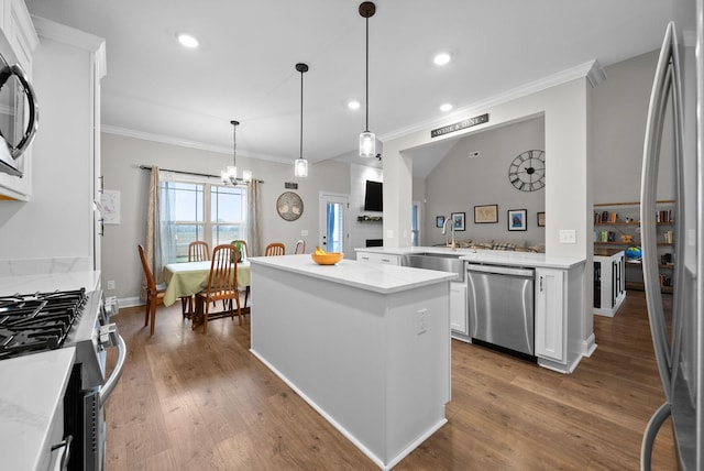 1885 Shield Dr, Clarksville, TN 37043 - kitchen with stainless steel appliances, wood finished floors, a sink, and crown molding