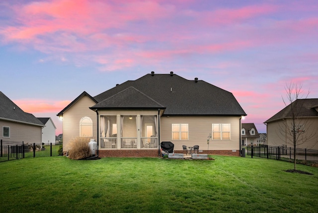 1885 Shield Dr, Clarksville, TN 37043 - back of house at dusk with a patio area, roof with shingles, a yard, and a fenced backyard