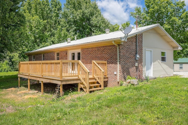 100 Hop Anderson Ln, Gainesboro, TN 38562 - rear view of property featuring a wooden deck, brick siding, a yard, and metal roof