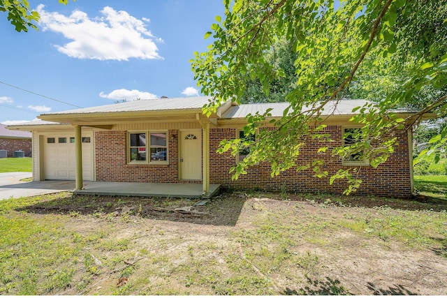100 Hop Anderson Ln, Gainesboro, TN 38562 - single story home featuring an attached garage, brick siding, concrete driveway, and metal roof