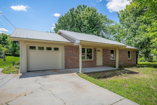 100 Hop Anderson Ln, Gainesboro, TN 38562 - ranch-style house featuring a garage, concrete driveway, metal roof, and brick siding