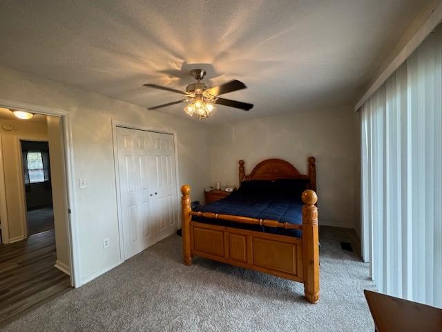 bedroom with ceiling fan, light carpet, a closet, and baseboards