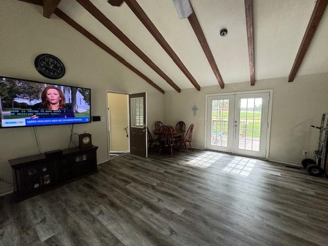 living room with wood finished floors, french doors, and vaulted ceiling with beams
