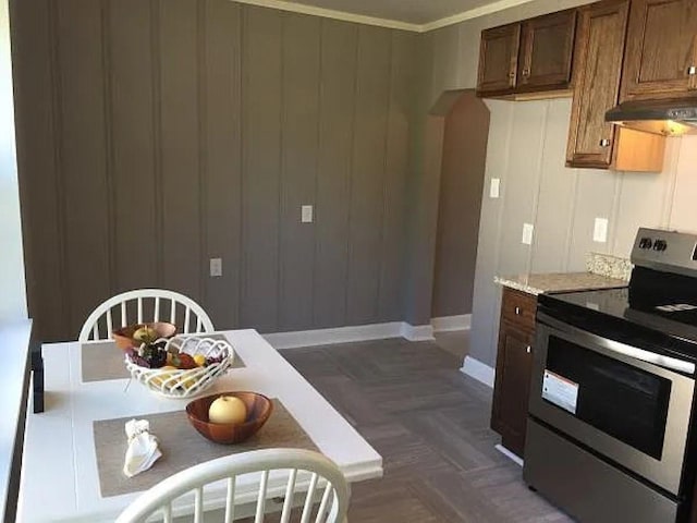 114 Hamblen Ave, Old Hickory, TN 37138 - kitchen featuring stainless steel range with electric cooktop, arched walkways, light countertops, baseboards, and under cabinet range hood
