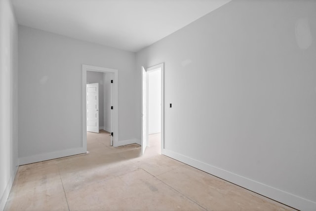 empty room featuring baseboards