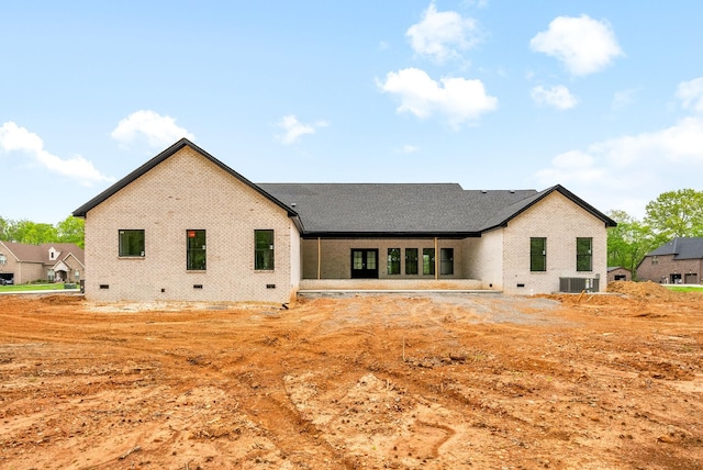 back of house with brick siding, central AC unit, and crawl space