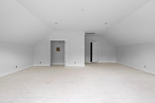 additional living space featuring lofted ceiling, baseboards, and visible vents