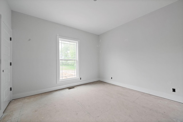unfurnished room with visible vents and baseboards