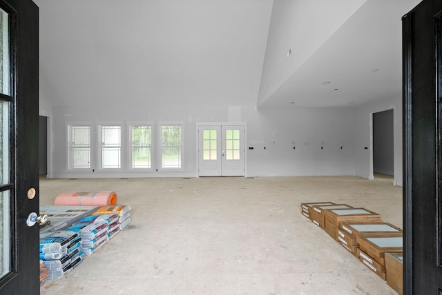 interior space with french doors and high vaulted ceiling