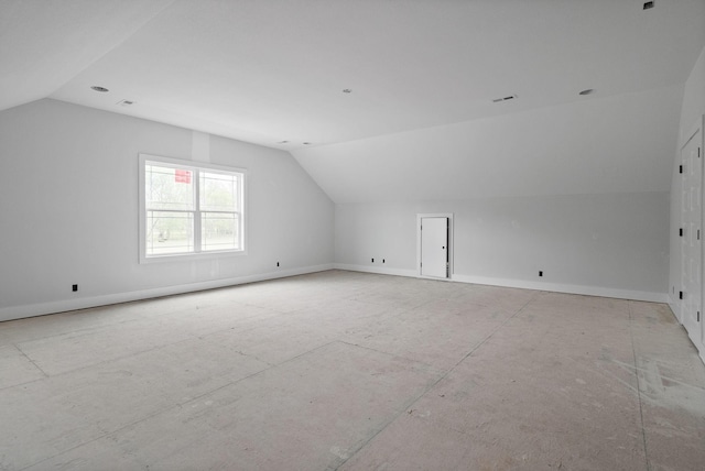 bonus room featuring lofted ceiling and baseboards
