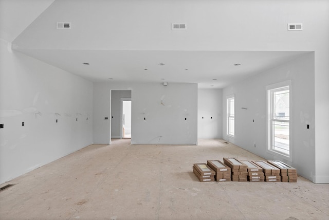 unfurnished living room with visible vents