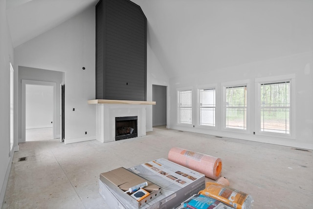 living room featuring a fireplace, visible vents, and high vaulted ceiling