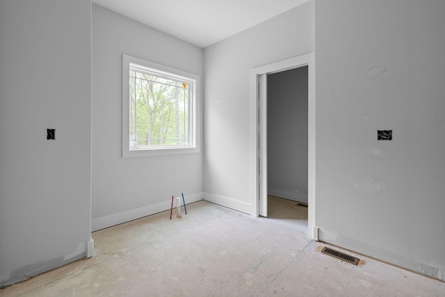 spare room featuring visible vents and baseboards