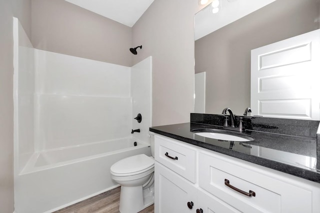 full bathroom with toilet, bathtub / shower combination, vanity, and wood finished floors