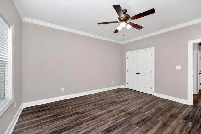 unfurnished bedroom with multiple windows, baseboards, dark wood-style floors, and crown molding