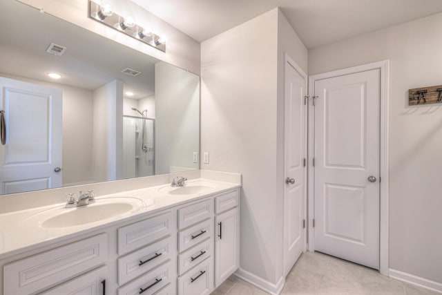 bathroom with visible vents, tile patterned floors, baseboards, and a sink
