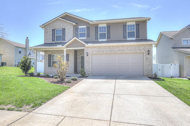 view of front of house featuring an attached garage, a front lawn, brick siding, and concrete driveway