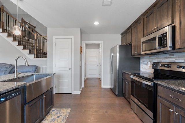 406 Bender Ct, Clarksville, TN 37042 - kitchen with dark stone countertops, dark brown cabinets, decorative backsplash, stainless steel appliances, and dark wood-style flooring