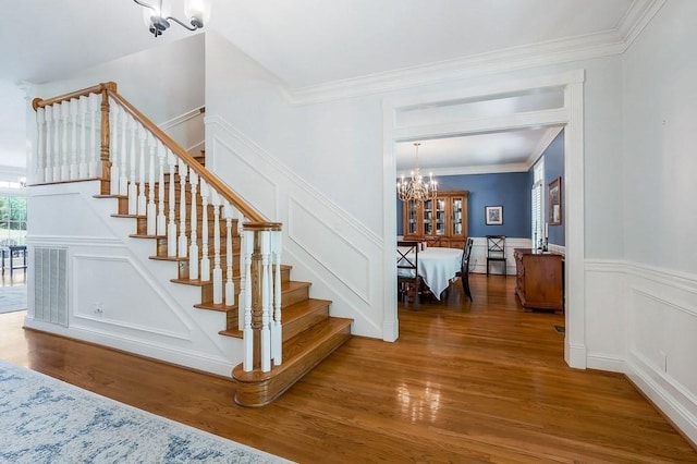 1319 N Plantation Dr, Cookeville, TN 38506 - staircase with wood finished floors, a decorative wall, a notable chandelier, and visible vents