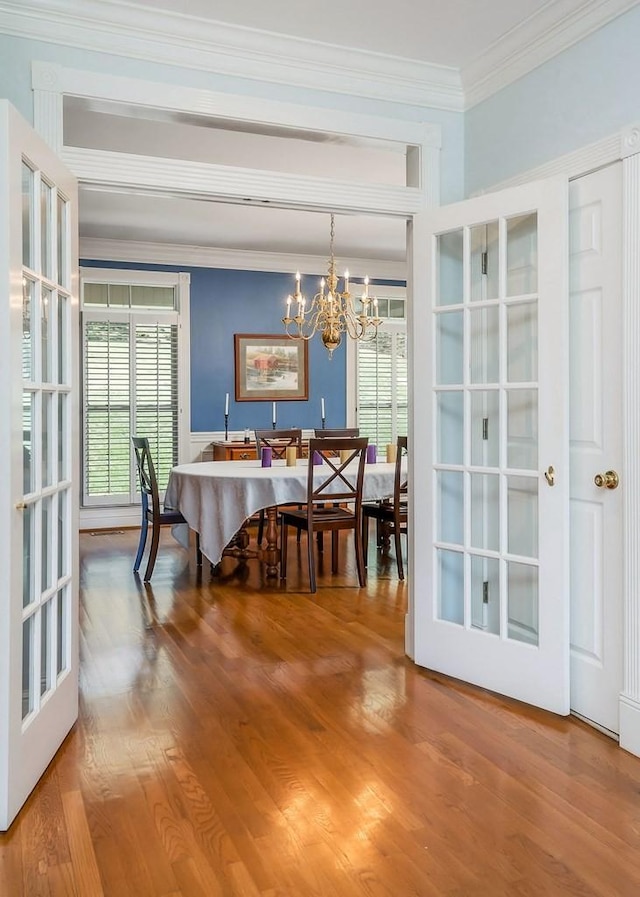 1319 N Plantation Dr, Cookeville, TN 38506 - dining area with wood finished floors, crown molding, and an inviting chandelier