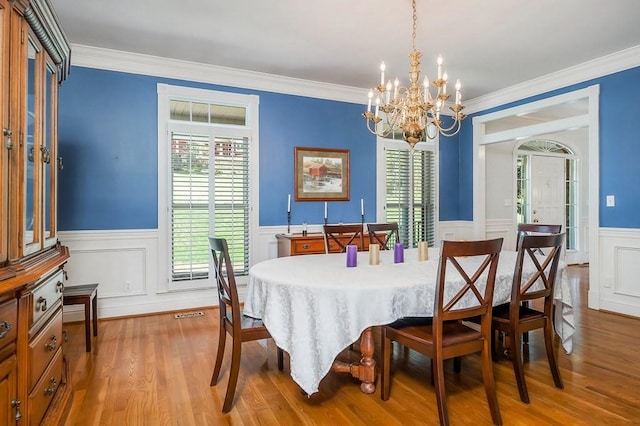 1319 N Plantation Dr, Cookeville, TN 38506 - dining space with wainscoting, ornamental molding, a notable chandelier, and wood finished floors