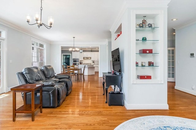 1319 N Plantation Dr, Cookeville, TN 38506 - living area featuring light wood-type flooring, baseboards, an inviting chandelier, built in shelves, and crown molding