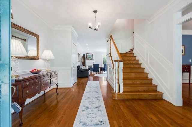 1319 N Plantation Dr, Cookeville, TN 38506 - foyer entrance featuring stairway, wood finished floors, a decorative wall, crown molding, and a notable chandelier