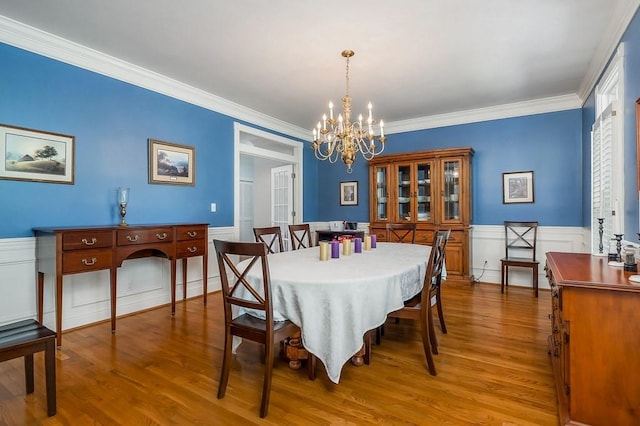 1319 N Plantation Dr, Cookeville, TN 38506 - dining space featuring a chandelier, wood finished floors, a wainscoted wall, and ornamental molding