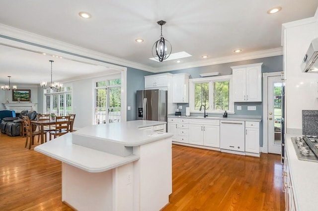 1319 N Plantation Dr, Cookeville, TN 38506 - kitchen featuring crown molding, a healthy amount of sunlight, appliances with stainless steel finishes, and a notable chandelier