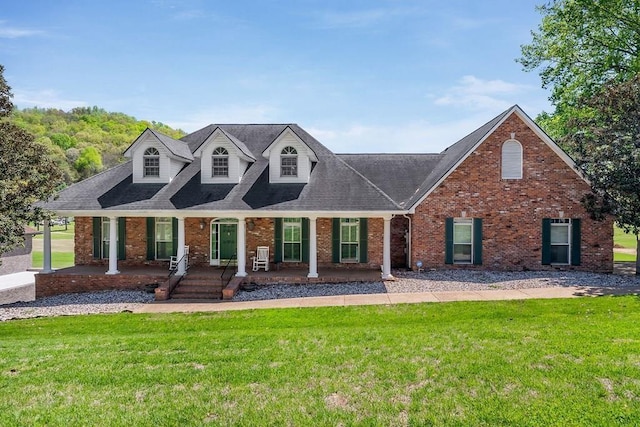 1319 N Plantation Dr, Cookeville, TN 38506 - cape cod house with brick siding, roof with shingles, a porch, and a front lawn