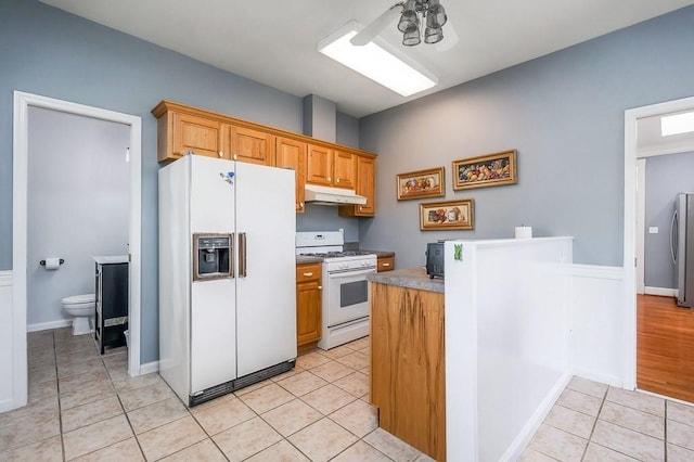 1319 N Plantation Dr, Cookeville, TN 38506 - kitchen featuring a peninsula, under cabinet range hood, white appliances, and light tile patterned floors
