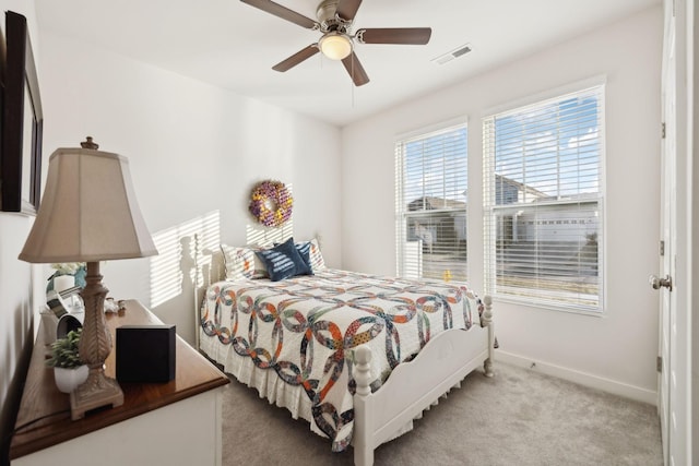bedroom featuring visible vents, carpet flooring, baseboards, and ceiling fan