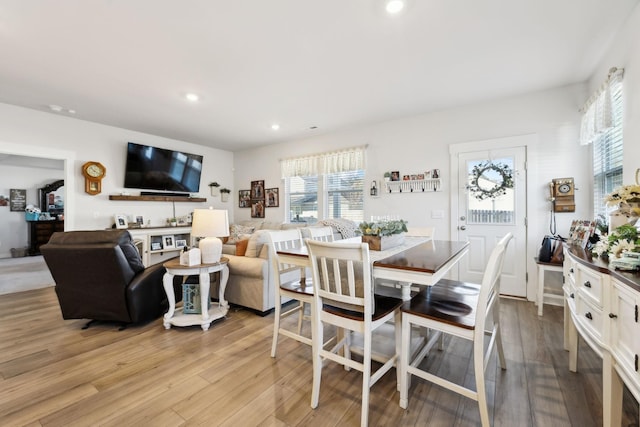 dining area with light wood finished floors and recessed lighting