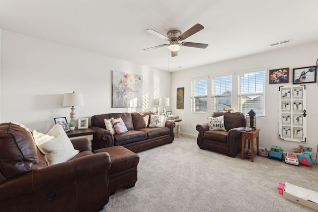 carpeted living area with a ceiling fan and visible vents