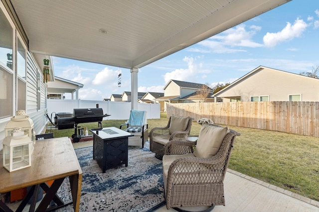 view of patio / terrace with a fenced backyard, grilling area, and an outdoor fire pit
