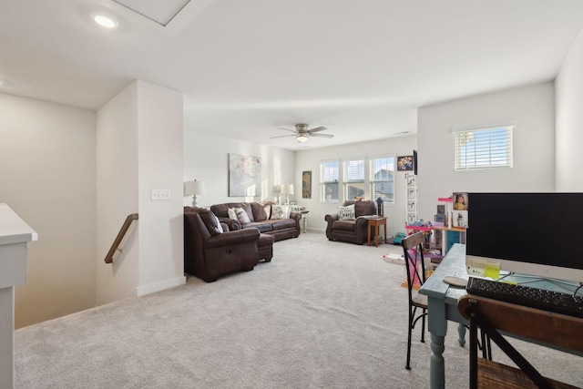 carpeted living room with a ceiling fan