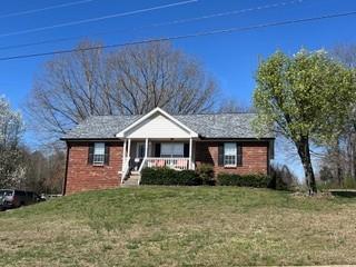 view of front of house featuring a porch and a front yard