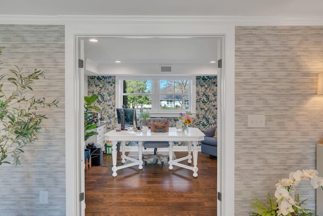 interior space with ornamental molding, wood finished floors, wallpapered walls, and visible vents
